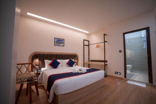 a bedroom with a large bed and a bathroom at Zip By Spree Hotels Gangtok in Gangtok