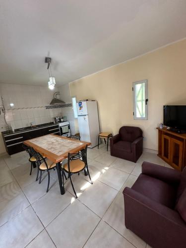 a kitchen and living room with a table and chairs at Hostal Del Sol Temporario in Rosario