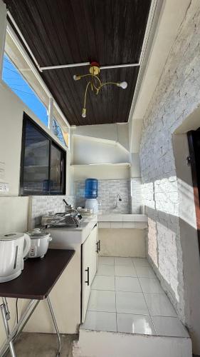 a kitchen with a sink and a bath tub at Huddle Pad in Baguio