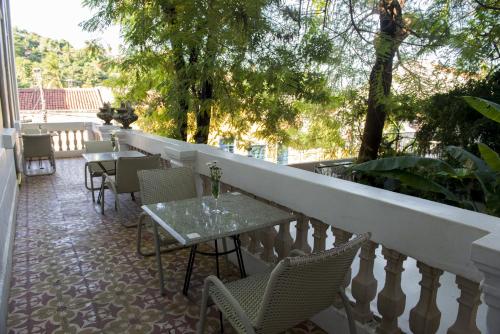 a patio with tables and chairs on a balcony at Pousada dos Quatro Cantos in Olinda