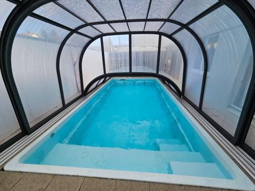 a swimming pool in a building with a large window at Royal Apartments & Rooms in Zagreb