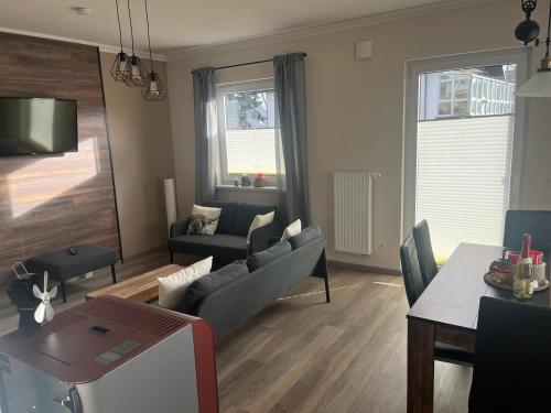 a living room with a couch and a table at Ferienhaus Pinieneck in Bad Laasphe