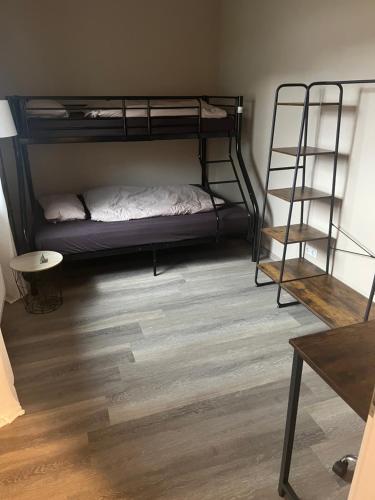 a room with two bunk beds and a table at Ferienhaus Pinieneck in Bad Laasphe