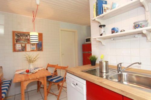 a kitchen with a sink and a table at Bungalow Nixe in Tarnewitz