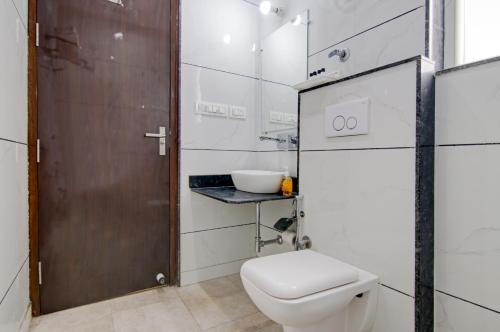 a bathroom with a toilet and a sink at Hotel DHD - PAHARGANJ in New Delhi
