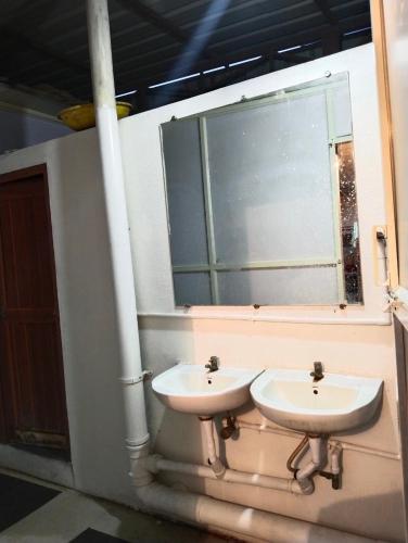 a bathroom with two sinks and a window at Arabian Residency in Bangalore