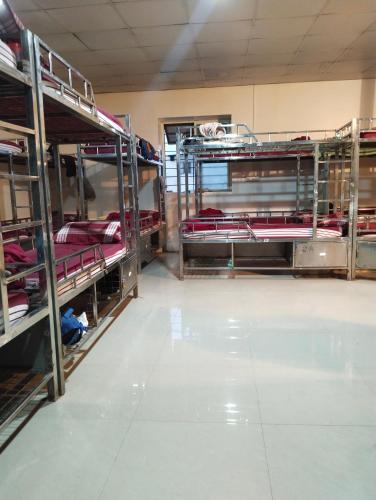 a room filled with lots of bunk beds at Arabian Residency in Bangalore