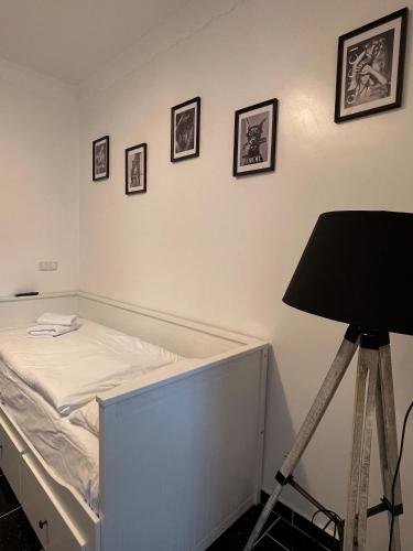 a bed in a room with a tripod and pictures on the wall at Villa Seebach in Boltenhagen