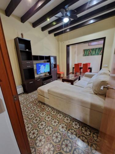 a bedroom with a large bed and a living room at Ganado26 in Sanlúcar de Barrameda
