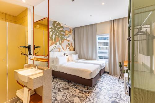 um quarto de hotel com uma cama e um lavatório em B&B HOTEL Santos Dumont no Rio de Janeiro