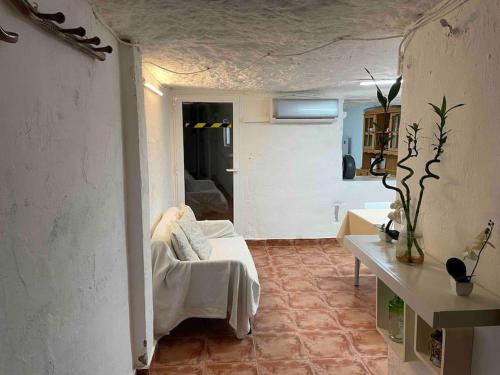 a living room with a couch and a table at LA CUEVA de TONI EL SECO in Paterna