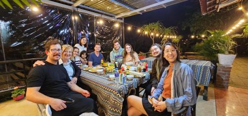 a group of people sitting at a table at Areca Bungalow in Phong Nha