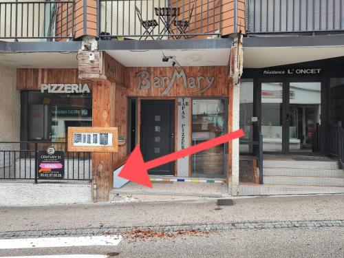 a store front with a red arrow in front of it at Residence l'Oncet - Appartement 8 personnes in Barèges