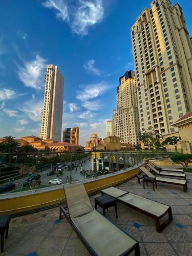 a group of benches in a city with tall buildings at the971stay in Dubai