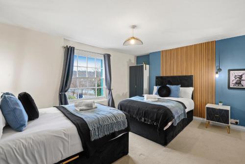 a bedroom with two beds and a window at Stunning Penthouse On Bristols Harbourside in Bristol