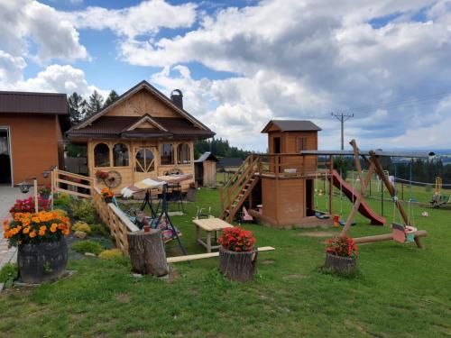 a park with a playground and a house at Willa Wyrostek in Bańska Wyżna