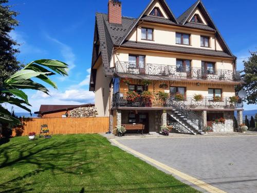a large house with balconies on a street at Willa Wyrostek in Bańska Wyżna