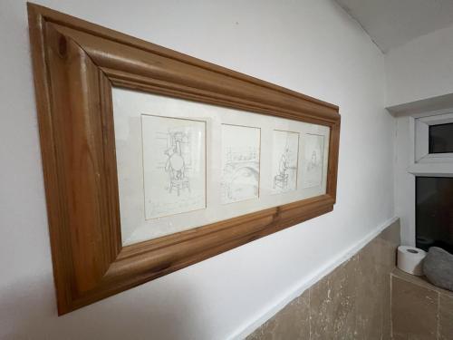 a picture frame on a wall with drawings on it at Hollies House in Retford