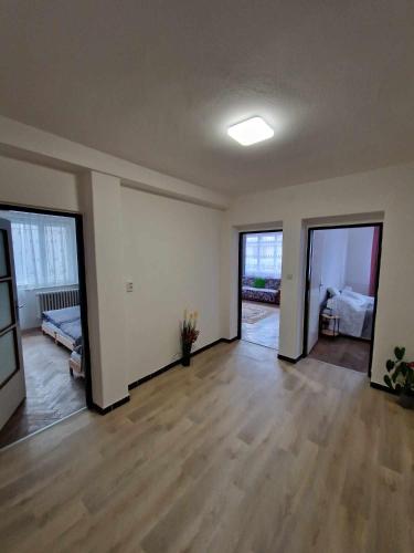 an empty living room with wooden floors and sliding doors at DáMa in Ružomberok