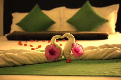 two swans made out of towels on a bed at Palm Beach Resort Ceylon in Jaffna