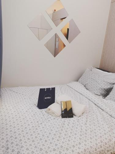 a book sitting on top of a bed with a mirror at Doroin Krib Staycation in Manila