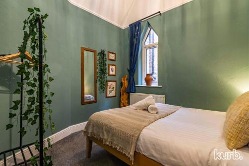 a bedroom with a bed in a green room at The Church House - 3 Bedroom House + Free Parking in Nottingham