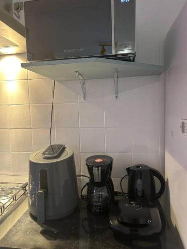 a kitchen with a toaster and a coffee maker on a counter at Casa de Ana - no coração de Bsb! in Brasilia