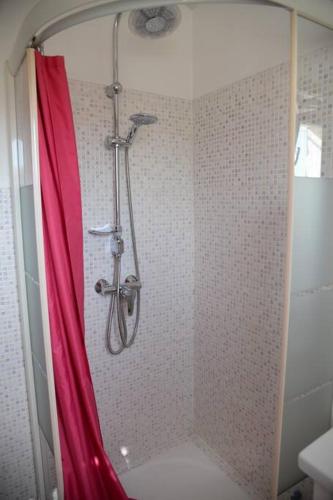 a shower with a red shower curtain in a bathroom at Bel Appartement En Haut de Villa in Sanary-sur-Mer
