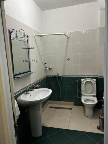 a bathroom with a sink and a toilet at Hotel Desaret in Pogradec