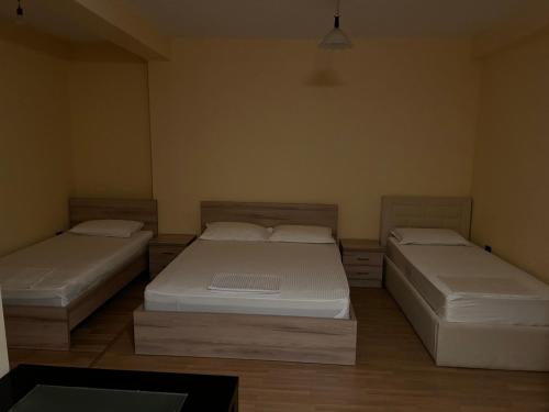 a room with two beds in a room at Hotel Desaret in Pogradec