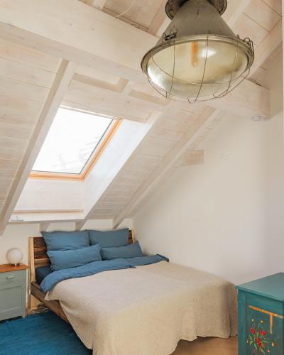 a bedroom with a bed and a ceiling with a light at Schöne Wohnung mit Bergblick in Weilheim in Oberbayern