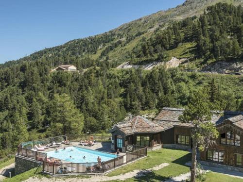 an aerial view of a house with a swimming pool at LES ARCS Appartement Prestige Ski In Ski Out in Bourg-Saint-Maurice