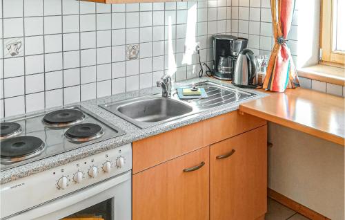 a kitchen with a sink and a stove at Beautiful Apartment In Patsch With Wifi And 2 Bedrooms in Innsbruck