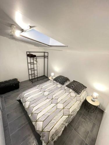 a bedroom with a large bed in a room at La maisonnette Saint-quentinoise in Saint-Quentin