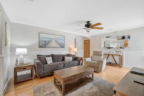 a living room with a couch and a table at Palm Tree Paradise in Bradenton