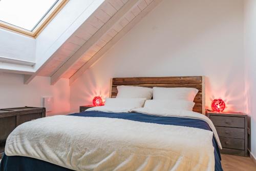 a bedroom with a large bed with two red lights at Schöne Wohnung mit Bergblick in Weilheim in Oberbayern