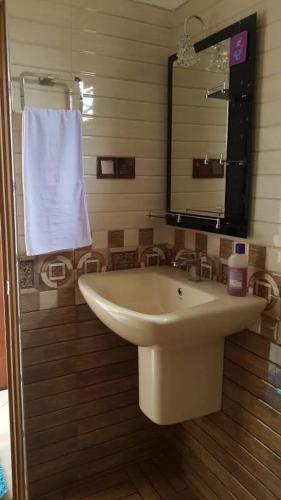 a bathroom with a white sink and a mirror at Blue sky villa in Mirissa