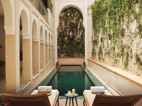 a swimming pool in the middle of a building at IZZA Marrakech in Marrakech