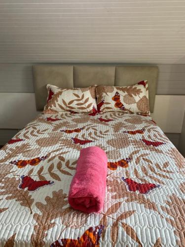 a pink towel laying on top of a bed at M D J Hayfields Guest House in Pietermaritzburg