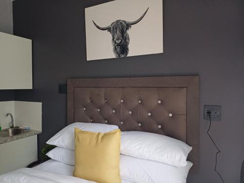 a bedroom with a bed with a bull picture on the wall at 16 on Ryde in Durban