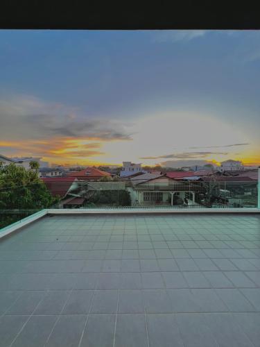 a view of a building with a sunset in the background at HeyFam Homestay in Sekincan