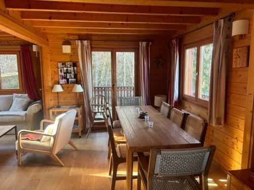 a dining room with a wooden table and chairs at Chalet de charme aux Carroz d'Arrâches-Flaines in Les Carroz d'Araches