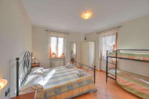 a bedroom with a bed and a bunk bed at Agriturismo L'Uliveto in Gargnano