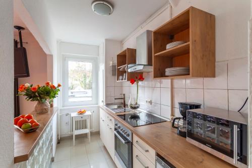 cocina con armarios de madera y encimera en City Apart Hannover, en Hannover
