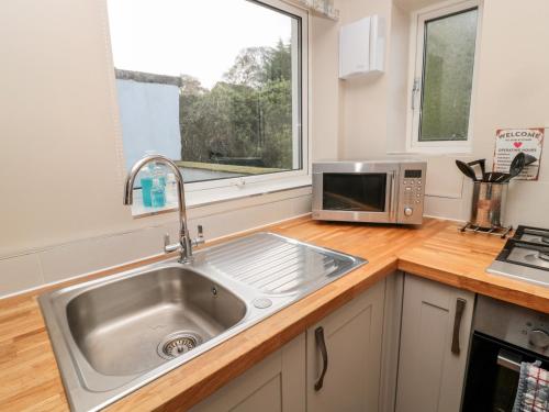 a kitchen with a sink and a microwave at The Anchorage in Alnwick
