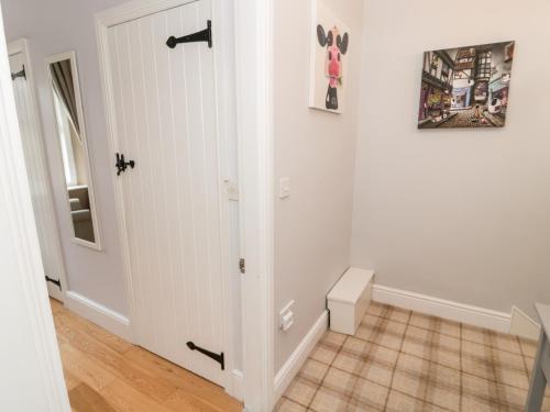 a hallway with a white door and a tile floor at The Anchorage in Alnwick