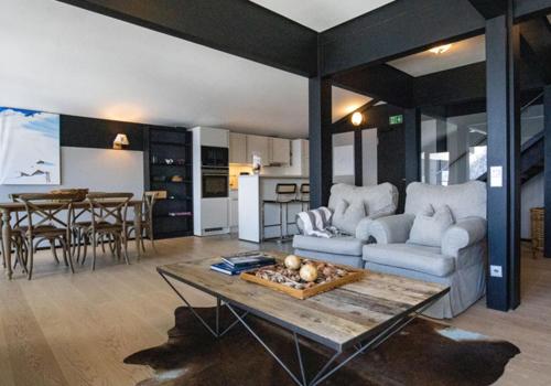 a living room with a couch and a table at Lauchernalp Resort Residences in Wiler