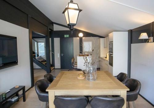 a dining room with a table and some chairs at Lauchernalp Resort Residences in Wiler