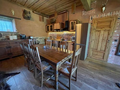 a kitchen with a wooden table and a refrigerator at Salu Jahimaja in Soontaga