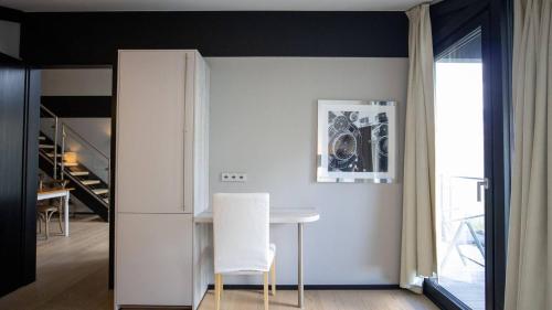a dining room with a white table and white chairs at Lauchernalp Resort Residences in Wiler